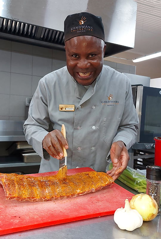 Chef applying marinade to ribs at The Desert Grace, Namibia